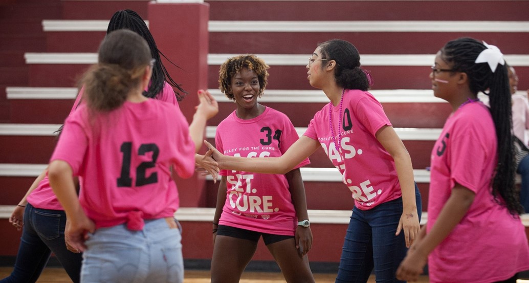 middle school volleyball team high-fiving