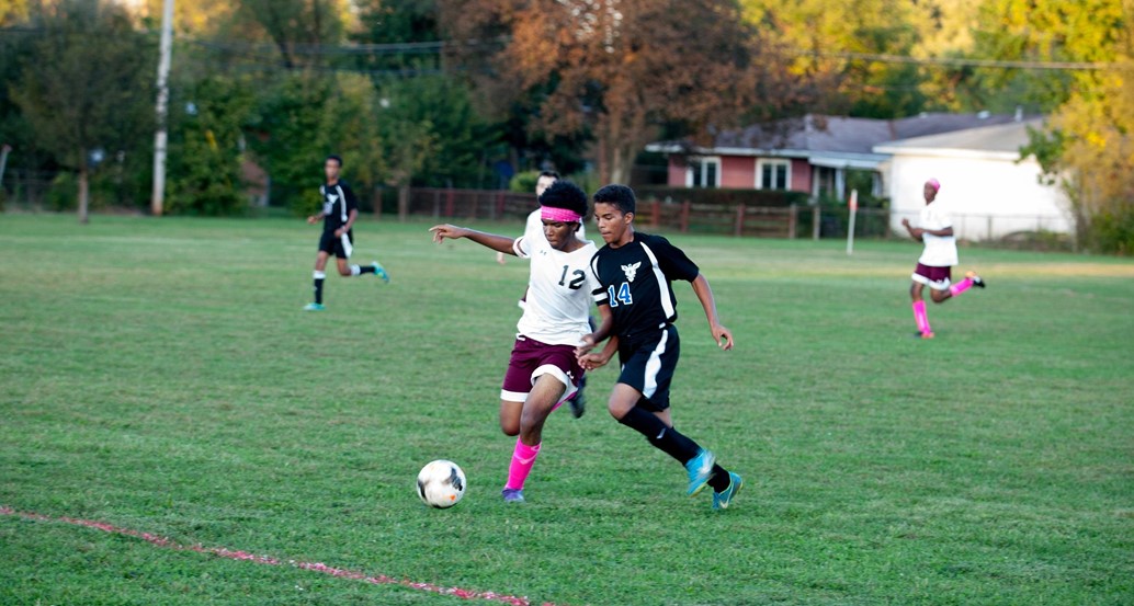 varsity soccer player going after ball
