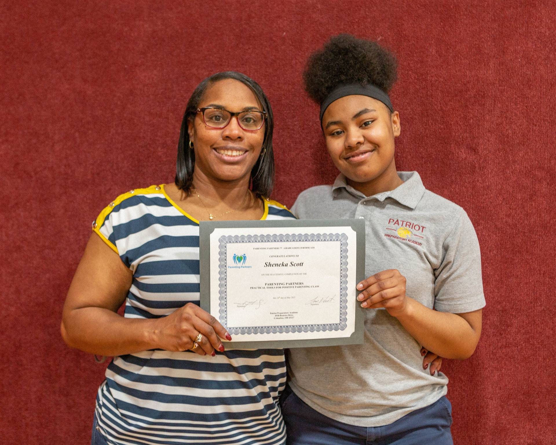 mother and daughter holding certificate
